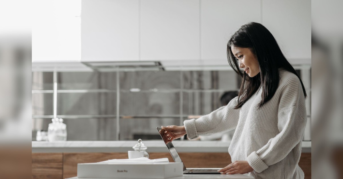 woman looking at a freshly opened laptop